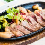Grilled Beef steak with vegetable in black plate